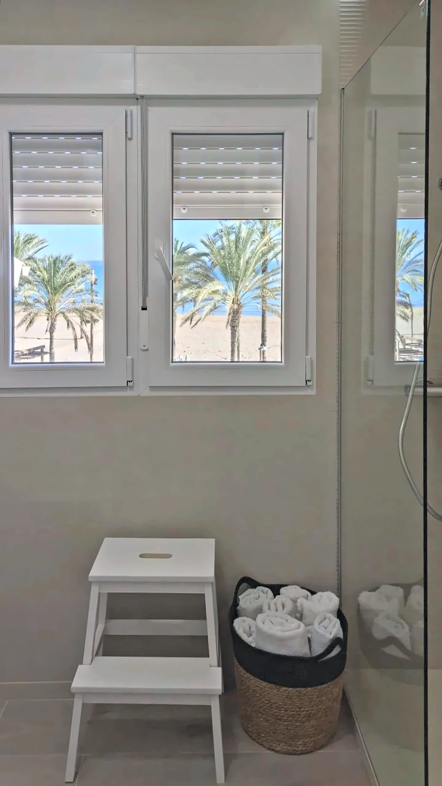 Baño con ventana a las palmeras de la playa